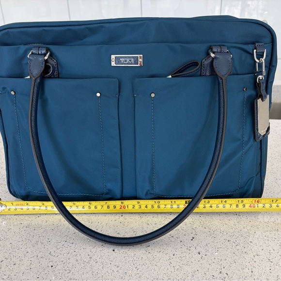 Tumi Other - TUMI Navy Carry-On.  Never used. Plastic still on inside zip.
